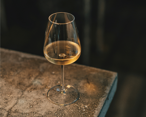 A glass of identikit by Marvla Tindo highlights its amber colour achieved in the winemaking process by 7 days of skin contact