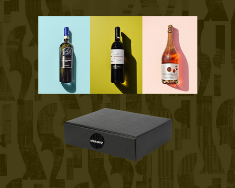 Three wine bottles on a colorful background with a wine box below.