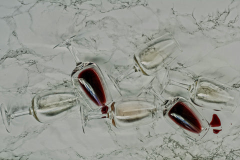 Set of wine glasses with red wine on a marble surface