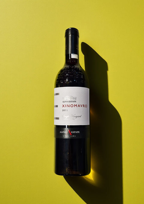 A bottle of Xinomavro red wine from Alpha Estate in Macedonia, showing the 2022 vintage on the label.