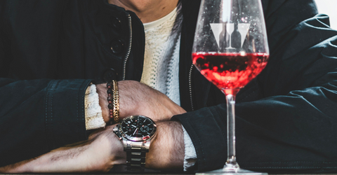 A wildcase branded glass containing a fresh light red wine